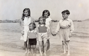 Auntie Sheila (back left), Auntie Irené (front centre), my father and the chauffeur's children on the beach