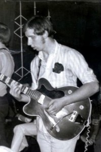 Robbie as a teenager with a guitar